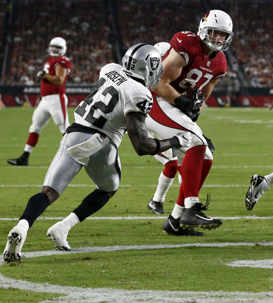 Arizona Cardinals tight end Troy Niklas (87) pulls in a touchdown pass as  Oakland Raiders strong safety Karl Joseph (42) defends during the first  half of an NFL preseason football game, Saturday, …