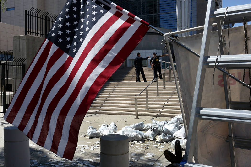 Bags of tea placed by protesters lie in a pile at the foot of the steps to the federal courthouse in Las Vegas on Monday , Aug. 14, 2017 during the Bunkerville standoff retrial. Michael Quine Las  ...