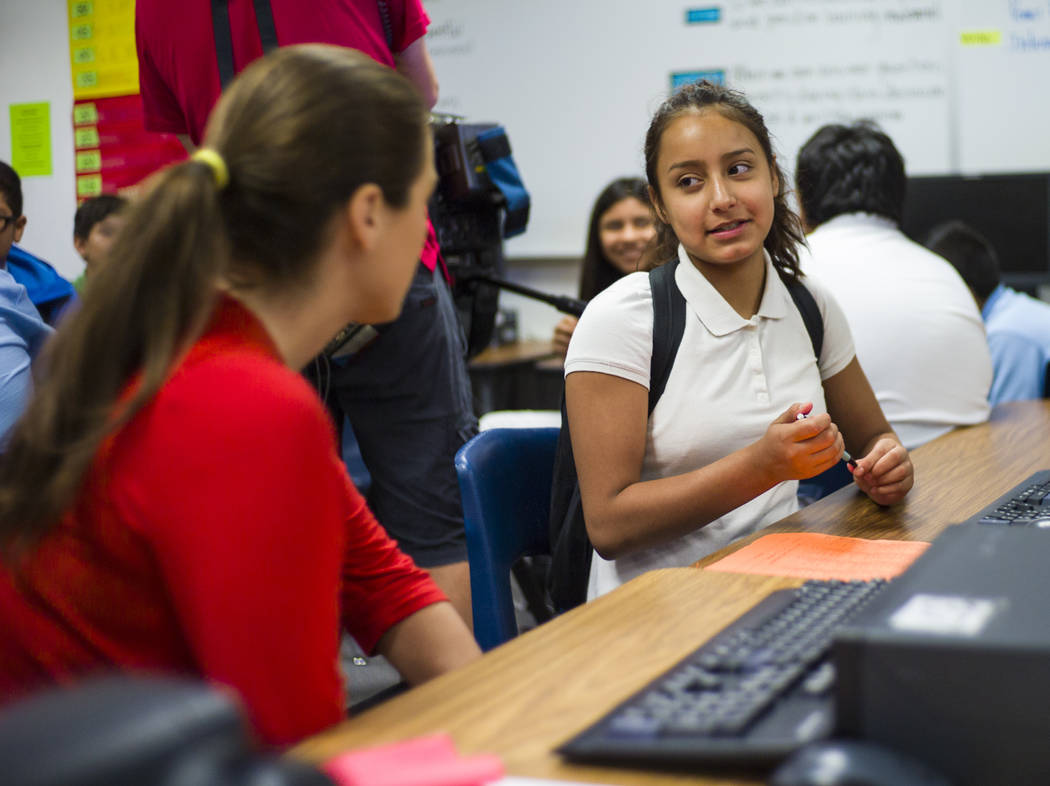 Clark County School Board District Trustee Lola Brooks, left, talks with seventh-grader Emely Sanchez, 12, an English language learning student, during the first day of classes at Garside Junior H ...