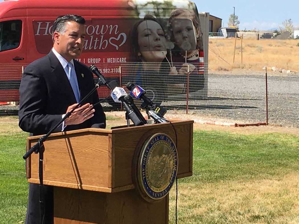 Sandoval, speaking outside Renown Health Urgent Care Clinic in Silver Springs on Tuesday, Aug. 15, 2017, said the 2018 carrier for rural counties will be SilverSummit, a subsidiary of Centene. Sea ...