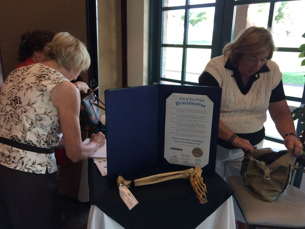 Stephanie Vondrak searches for a pen as a Lions Club member checks in Aug. 7, 2017. The Lions Club is supporting the efforts of Allan Stahl, cardiologist, who is opening a Saturday clinic near Sum ...