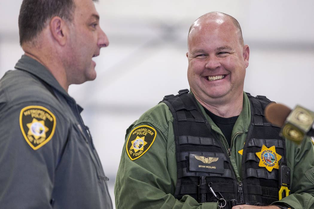 Bryan Woolard, a helicopter pilot, right, laughs with Chief Pilot Steve Morris Jr. before unveiling the new Las Vegas Metropolitan Police helicopter at the North Las Vegas Airport on Wednesday, Au ...