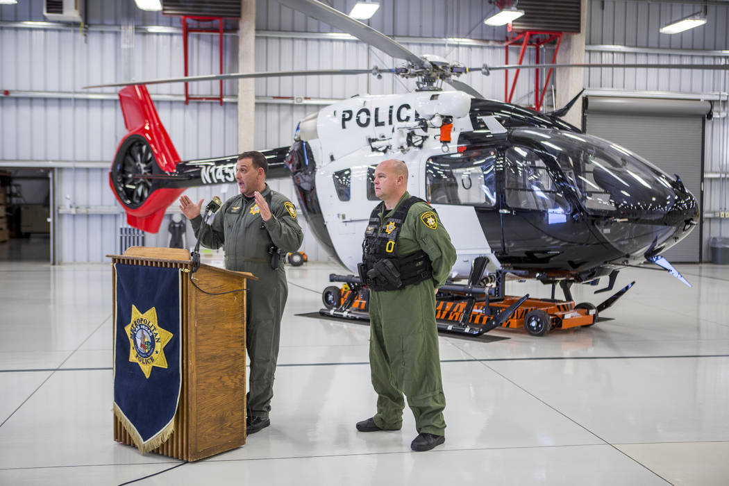 Chief Pilot Steve Morris Jr., left, speaks about the new Las Vegas Metropolitan Police helicopter while pilot Bryan Woolard stands by at the North Las Vegas Airport on Wednesday, Aug. 16, 2017.  P ...