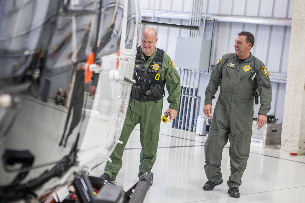 Chief Pilot Steve Morris Jr., right,  and pilot Bryan Woolard prepare the new Las Vegas Metropolitan Police helicopter for flight at the North Las Vegas Airport on Wednesday, Aug. 16, 2017.  Patri ...
