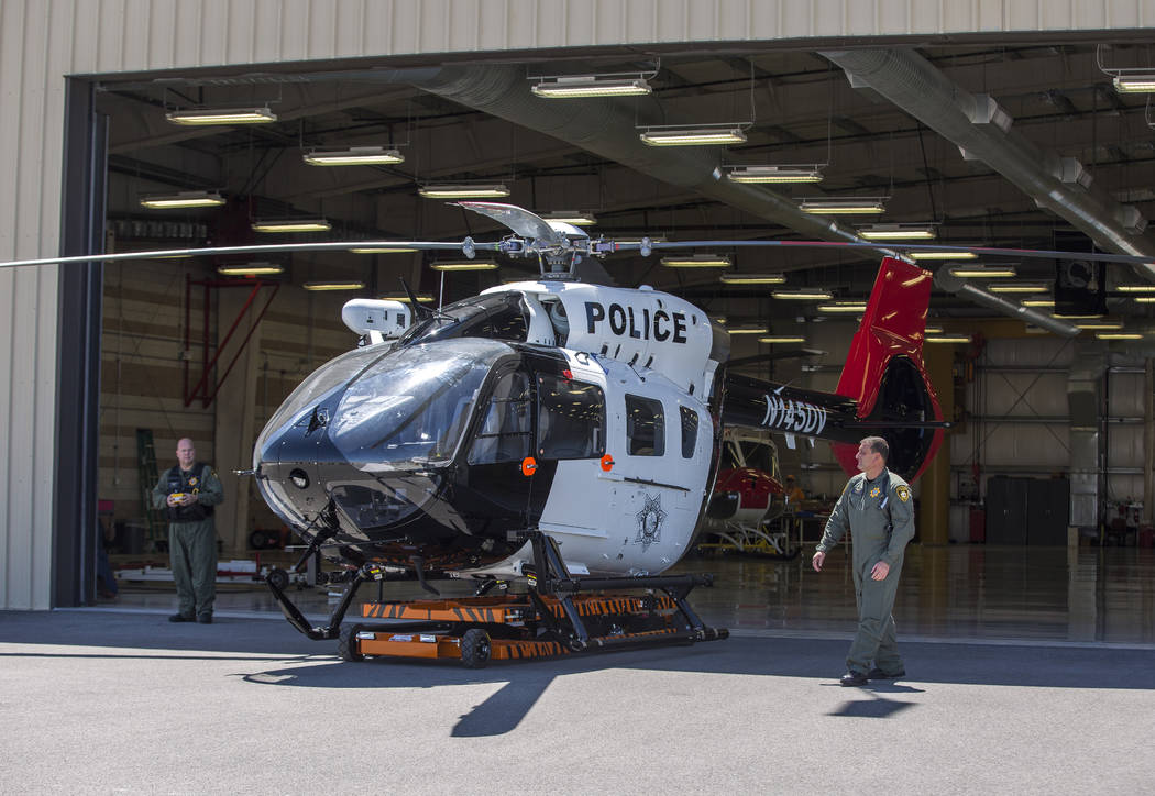 Chief Pilot Steve Morris Jr., right,  and pilot Bryan Woolard bring out the new Las Vegas Metropolitan Police helicopter for flight at the North Las Vegas Airport on Wednesday, Aug. 16, 2017.  Pat ...