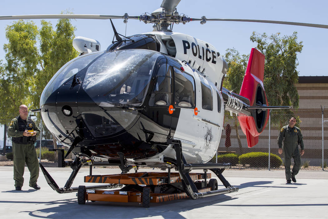 Chief Pilot Steve Morris Jr., right,  and pilot Bryan Woolard bring out the new Las Vegas Metropolitan Police helicopter for flight at the North Las Vegas Airport on Wednesday, Aug. 16, 2017.  Pat ...