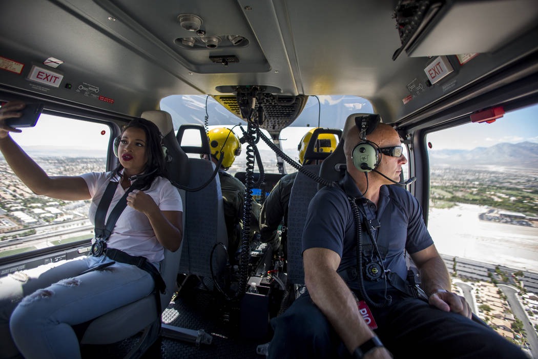 Chernéy Amhara of FOX5, left, and police spokesman Larry Hadfield, right in the new Las Vegas Metropolitan Police helicopter on Wednesday, Aug. 16, 2017.  Patrick Connolly Las Vegas Review-Jo ...