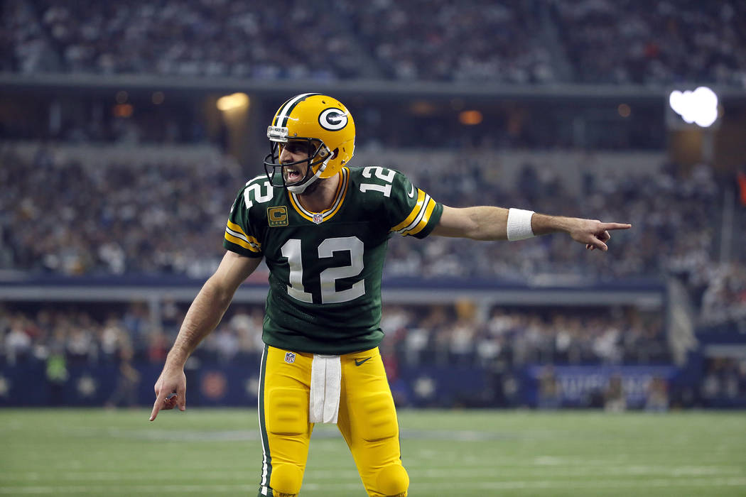 Green Bay Packers quarterback Aaron Rodgers (12) signals at the line of scrimmage during an NFL football game against the Dallas Cowboys on Sunday, Jan. 15, 2017, in Arlington, Texas. (AP Photo/Ro ...