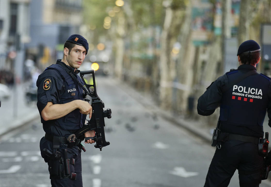 Armed police officers patrol a deserted street in Las Ramblas, in Barcelona, Spain, Friday, Aug. 18, 2017. (AP Photo/Manu Fernandez)