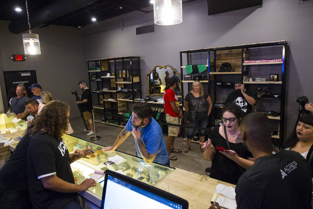 Budtender Tom Nieves, left, assists customer Ethan, of Henderson, during the first day of recreational marijuana sales at Acres Cannabis in Las Vegas on Saturday, July 1, 2017. Chase Stevens Las V ...