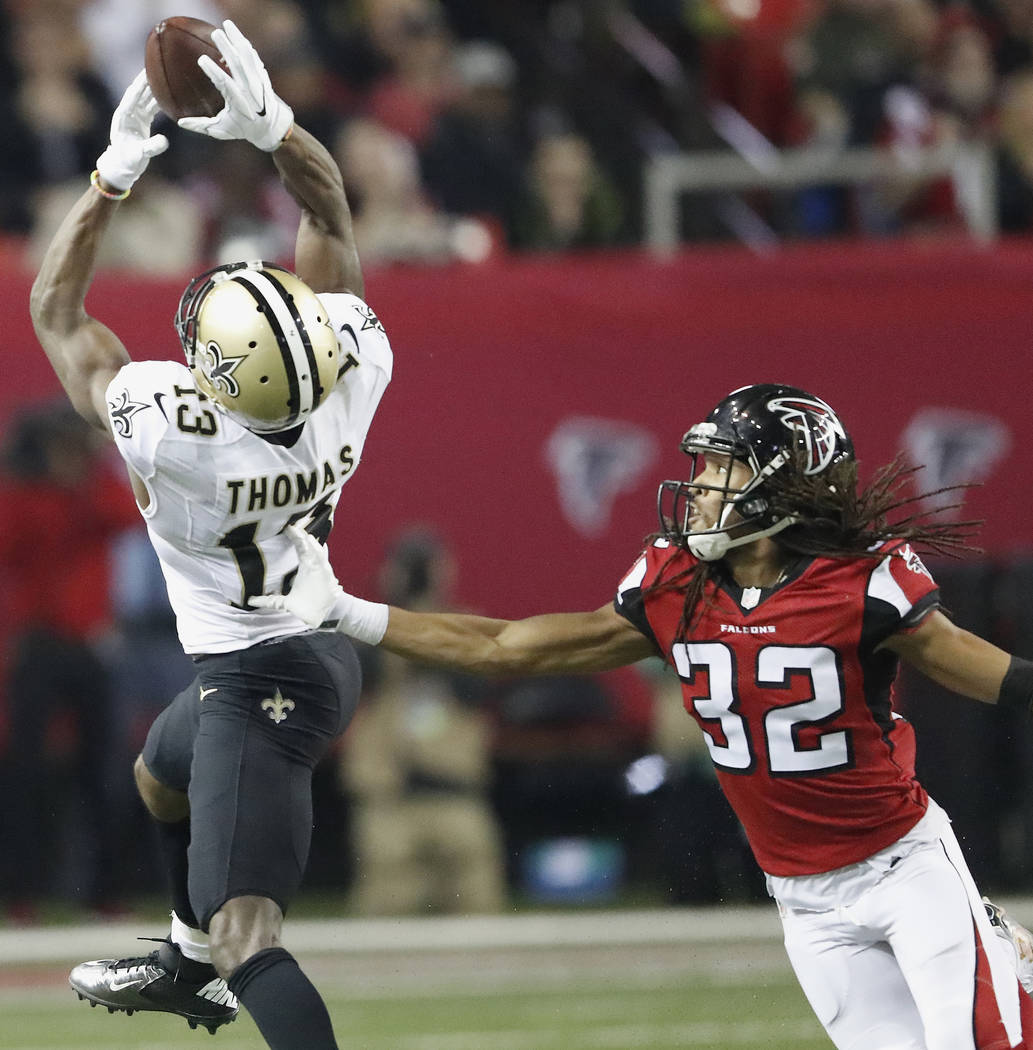New Orleans Saints wide receiver Michael Thomas (13) makes the catch against Atlanta Falcons cornerback Jalen Collins (32) during the second half of an NFL football game, Sunday, Jan. 1, 2017, in ...