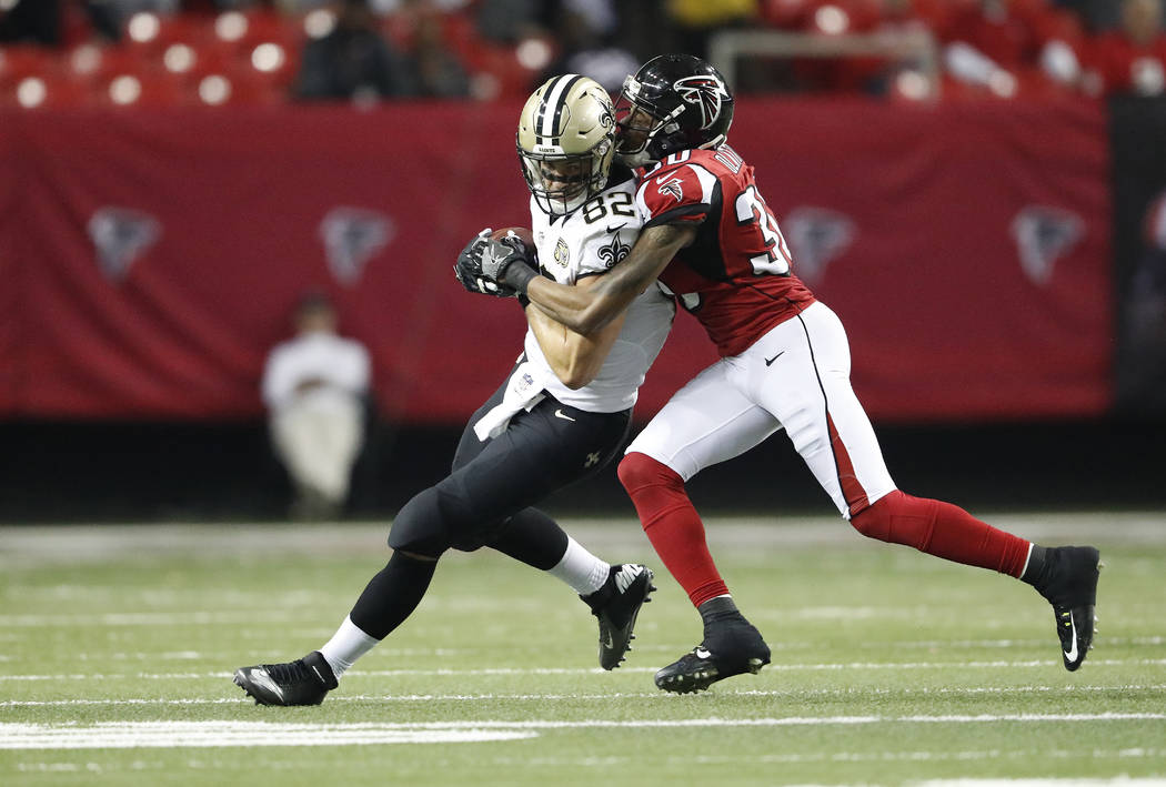 Atlanta Falcons cornerback Deji Olatoye (30) tackles New Orleans Saints tight end Coby Fleener (82) during the second half of an NFL football game, Sunday, Jan. 1, 2017, in Atlanta. (AP Photo/John ...