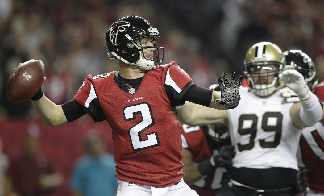 Atlanta Falcons quarterback Matt Ryan (2) passes the ball as New Orleans Saints defensive end Paul Kruger (99) looks on during the first half of an NFL football game, Sunday, Jan. 1, 2017, in Atla ...