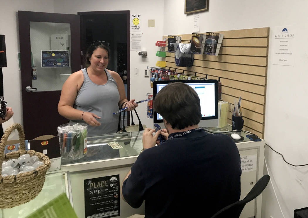 Anna Wroble, 37, buys five pairs of solar eclipse glasses at the College of Southern Nevada's Planetarium Thursday, Aug. 17, 2017. Jessie Bekker Las Vegas Review-Journal