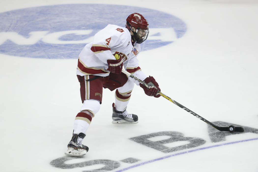 Denver's Will Butcher skates the puck up the ice in the second period during the midwest regional final of the NCAA college hockey tournament against Penn State, Sunday, March 26, 2017, in Cincinn ...