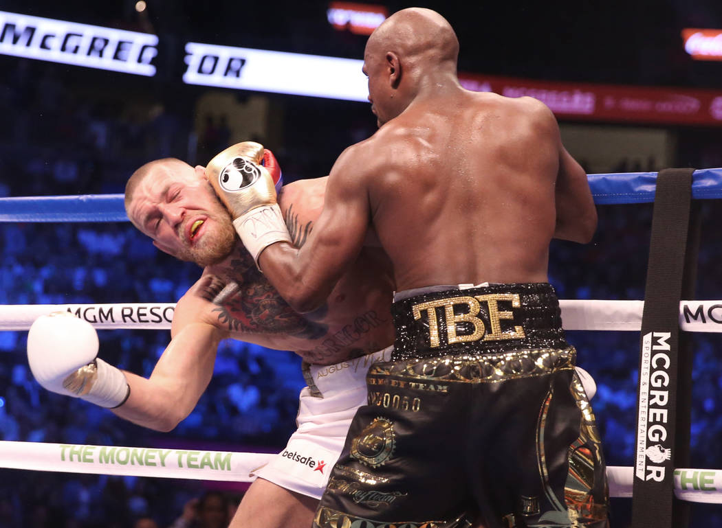 Floyd Mayweather, right, lands a punch against Conor McGregor in the blank round on Saturday, Aug 26, 2017, at T-Mobile Arena, in Las Vegas. Benjamin Hager Las Vegas Review-Journal @benjaminhphoto
