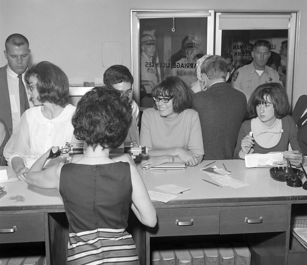 Couples rush to secure a marriage license and get married ahead of a military draft deadline, Aug. 25, 1965. (Milt Palmer/Las Vegas News Bureau)
