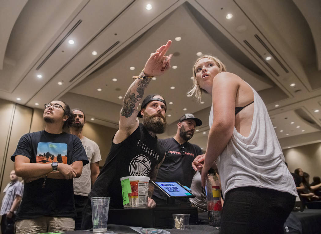Ben Heath, left, buys band shirts from Kat Cody at the merch stand during Psycho Las Vegas on Friday, Aug 18, 2017, at the Hard Rock hotel-casino, in Las Vegas. Benjamin Hager Las Vegas Review-Jou ...