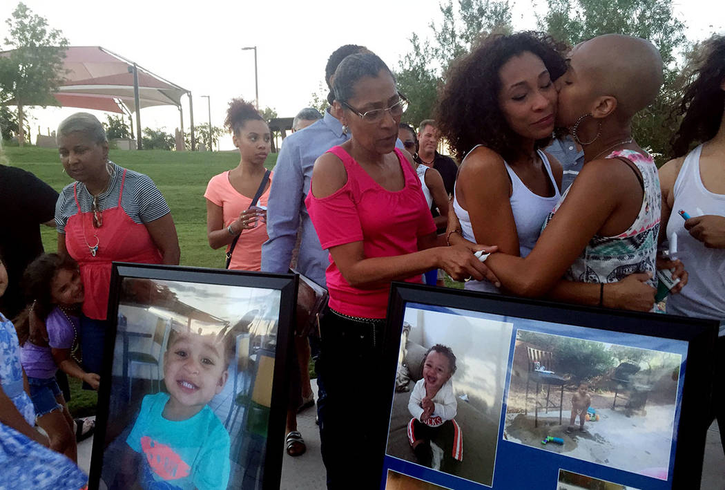Gabrielle Branon, second from right, mother of DaeVon Branon-Banks, a 20-month-old toddler killed last week, is consoled after release balloons in his honor on Sunday, Aug. 20, 2017, in Las Vegas. ...