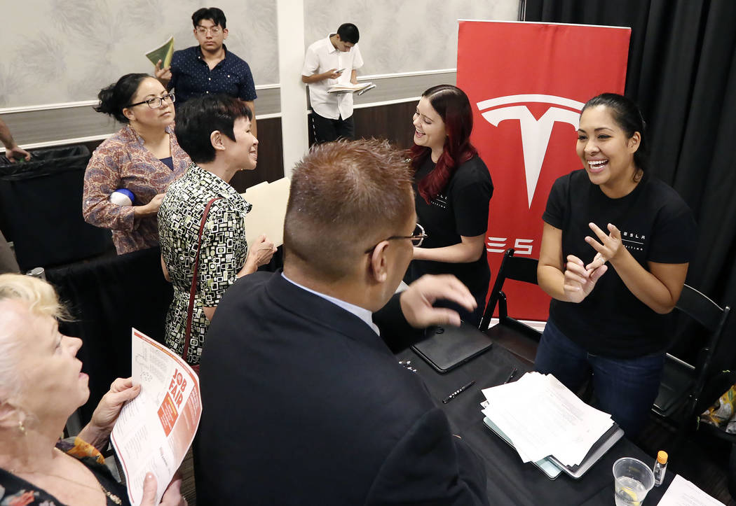 Job seekers meet with Ashley Summer, right, customer service recruiter for Tesla, during a job fair hosted by the Las Vegas Review-Journal at Palace Station on Thursday, Aug. 17, 2017, in Las Vega ...