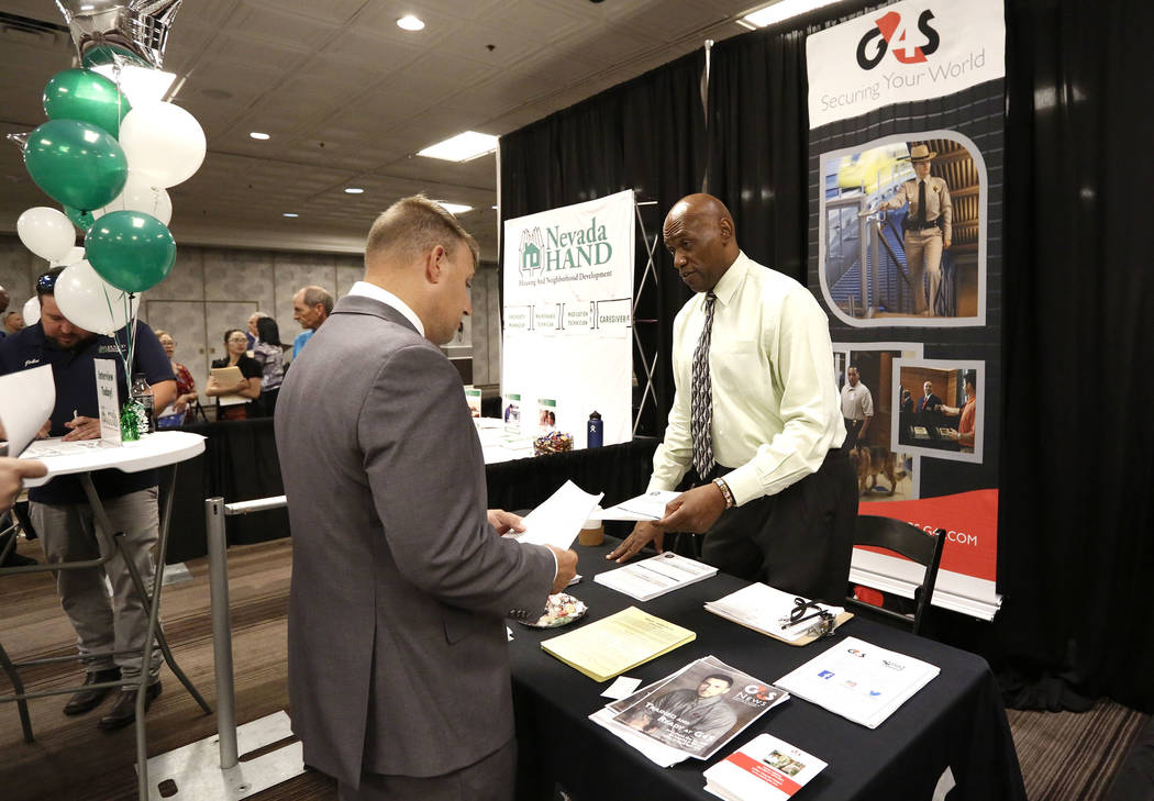Human Resources Manager at G4S Secure Solutions, Inc., Timothy Wells, right, talks to a job seeker during a job fair hosted by the Las Vegas Review-Journal at Palace Station on Thursday, Aug. 17,  ...