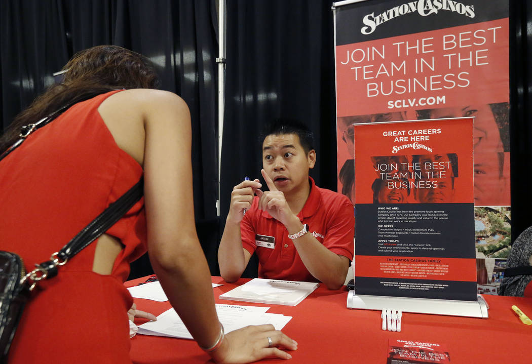 Jason Luong, right, employment recruiter for Texas Station & Fiesta Rancho, talks to a job seeker during a job fair hosted by the Las Vegas Review-Journal at Palace Station on Thursday, Aug. 1 ...