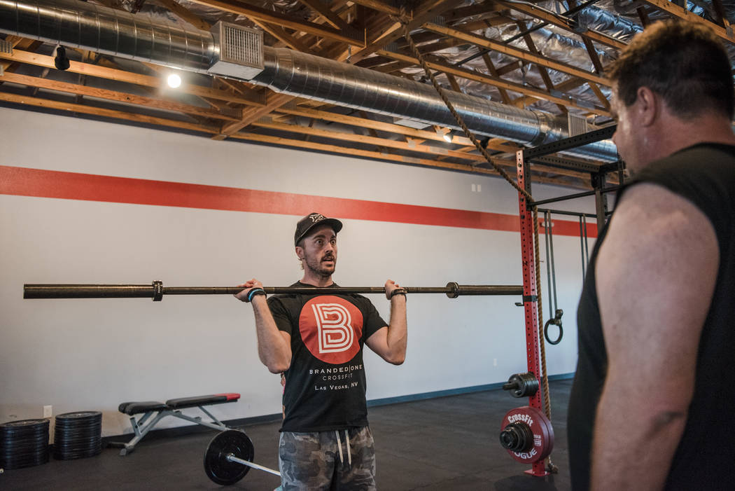 Founder Nick McCombs shows Gary Bartusch a dead lift exercise at Branded One Cross Fit on Thursday, Aug. 25, 2017, in Las Vegas. Morgan Lieberman Las Vegas Review-Journal