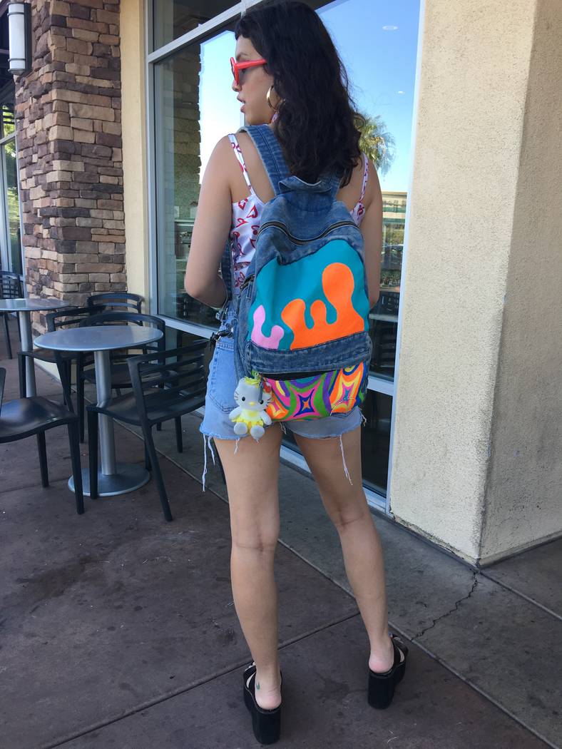 Malia Yanos, 23, of the northwest valley showing off a backpack that she painted for her brand Trippy Neon on August 22, 2017. (Kailyn Brown/ View) @KailynHype