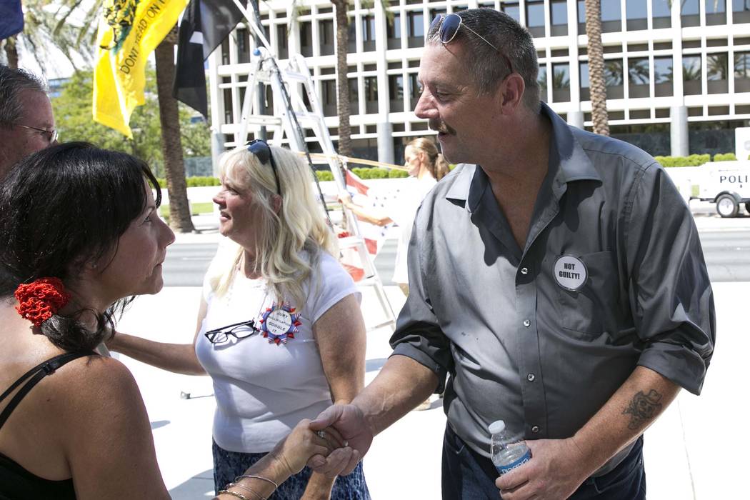 Ricky Lovelien shakes hands with Cindy Lake outside the Lloyd George U.S. Courthouse on Wednesday, Aug. 23, 2017, in Las Vegas. Lovelien and three other defendants in the Bunkerville standoff case ...