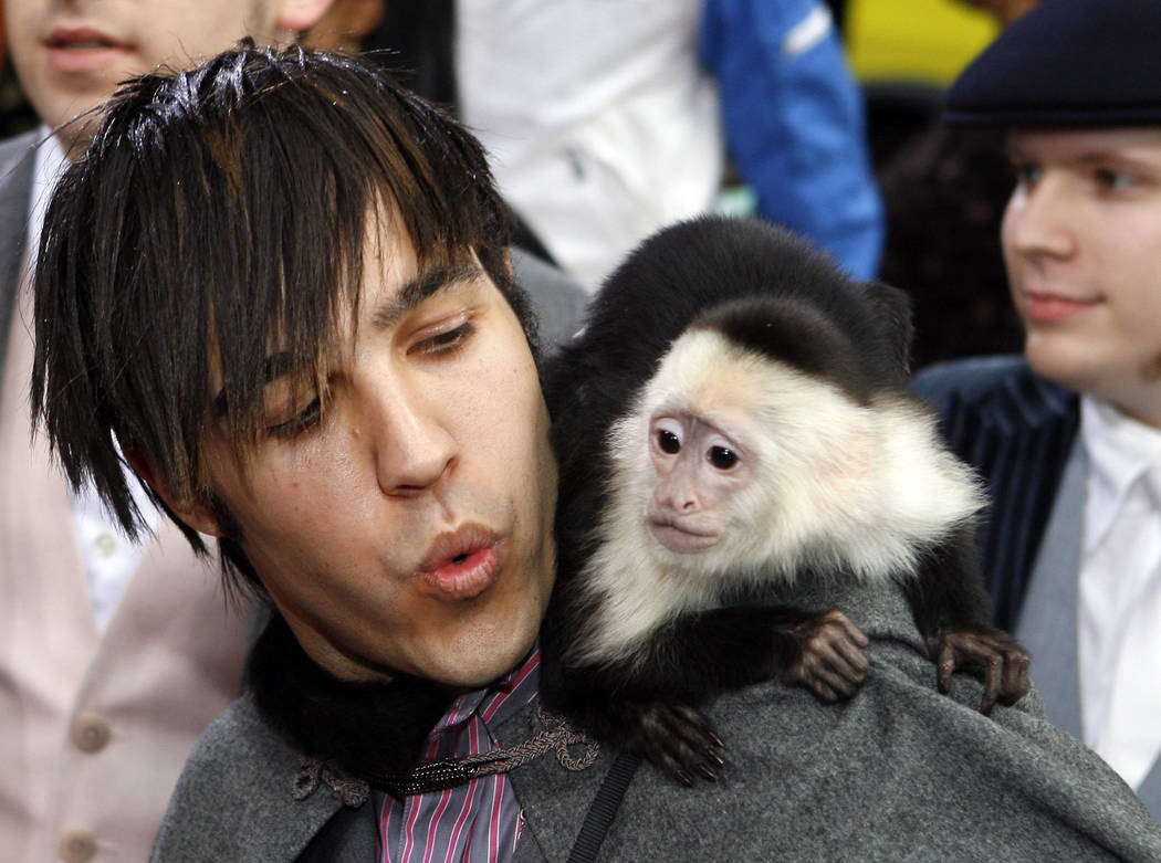 Pete Wentz, from the group Fall Out Boy, arrives with a monkey at the 2006 MTV Video Music Awards in New York, on Thursday, Aug. 31, 2006.  (AP Photo/Jason DeCrow)
