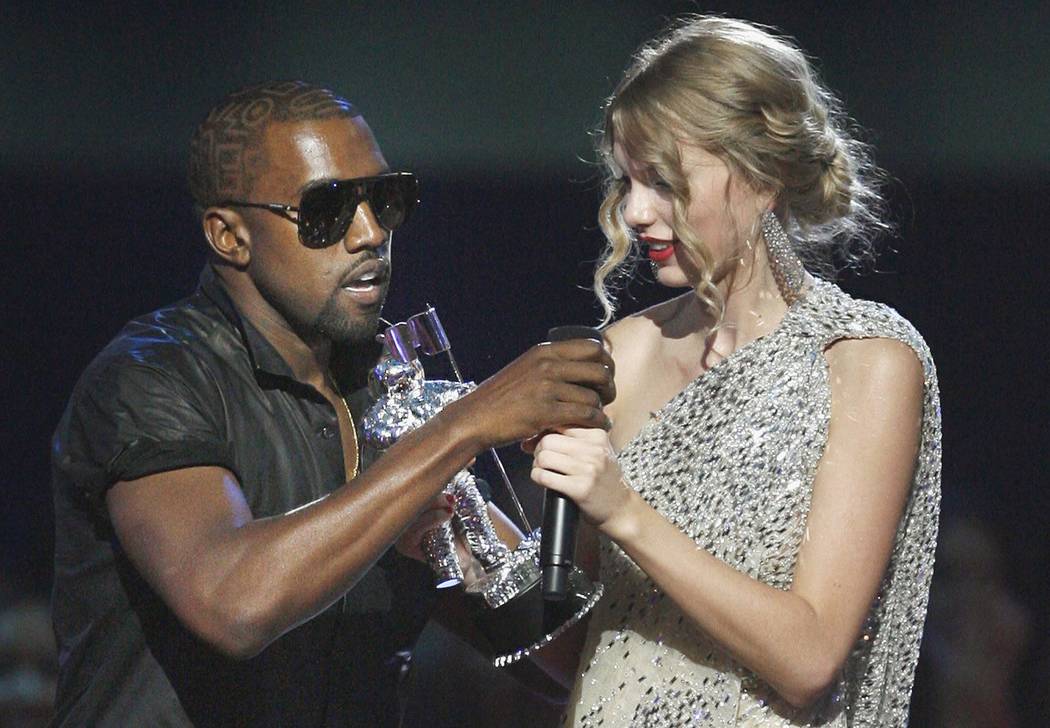 FILE - In this Sept. 13, 2009 file photo, singer Kanye West takes the microphone from singer Taylor Swift as she accepts the &quot;Best Female Video&quot; award during the MTV Video Music  ...