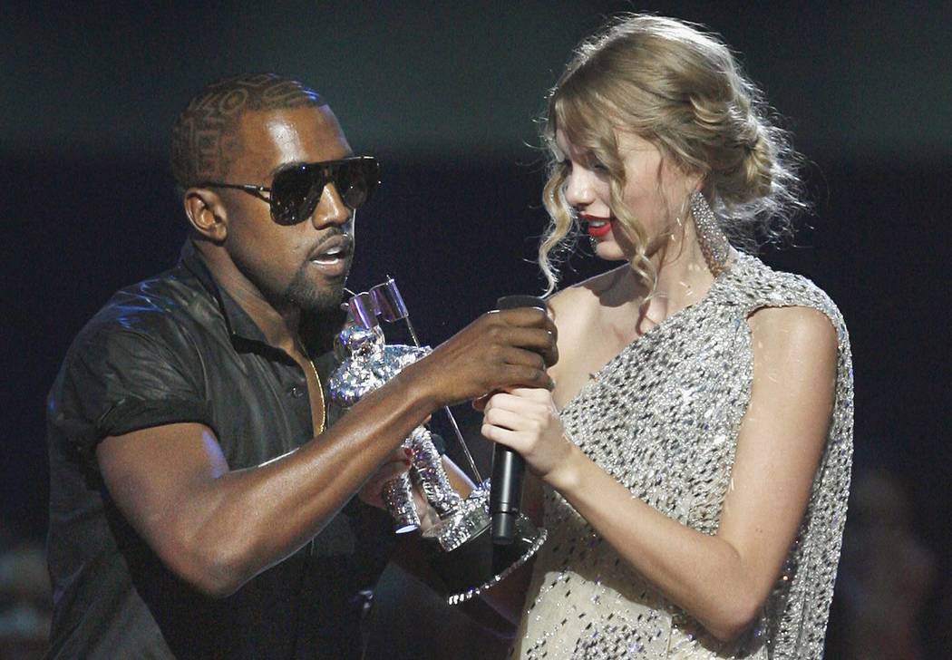 FILE - In this Sept. 13, 2009 file photo, singer Kanye West takes the microphone from singer Taylor Swift as she accepts the "Best Female Video" award during the MTV Video Music ...