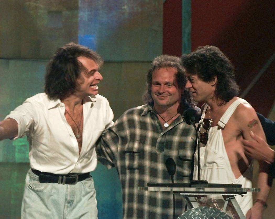 David Lee Roth, left, reunites with former bandmates Michael Anthony, center, and Eddie Van Halen at the MTV Video Music Awards in New York Wednesday, Sept. 4, 1996. (AP Photo/Bebeto Matthews)