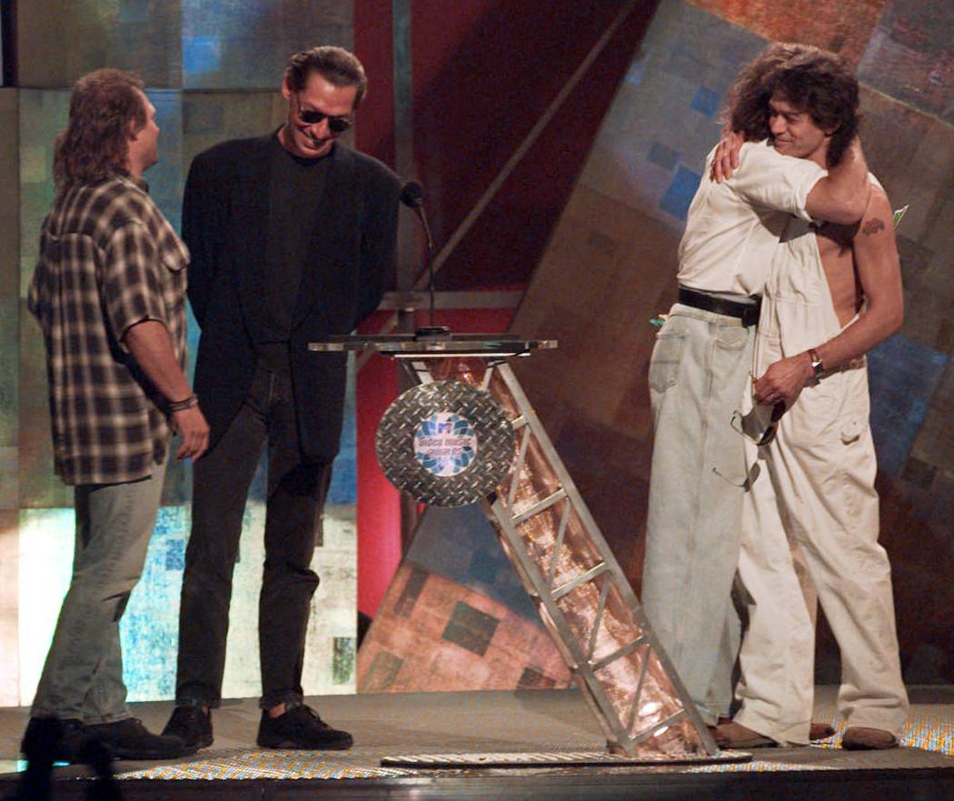 Former Van Halen bandmates David Lee Roth and Eddie Van Halen, right, embrace as they are reunited onstage at the MTV Video Music Awards in New York Wednesday, Sept. 4, 1996.  Bandmates  Michael A ...