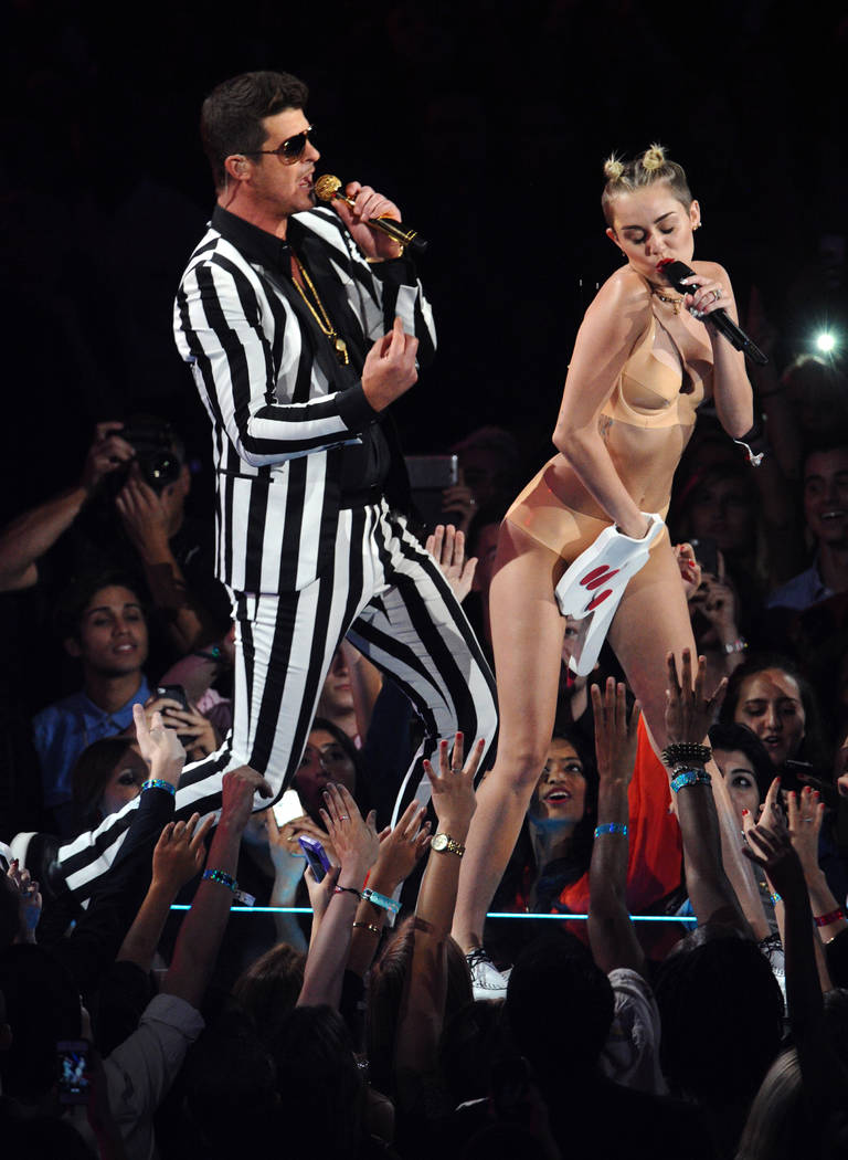 Robin Thicke, left, and Miley Cyrus perform &quot;Blurred Lines&quot; at the MTV Video Music Awards on Sunday, Aug. 25, 2013, at the Barclays Center in the Brooklyn borough of New York. (P ...