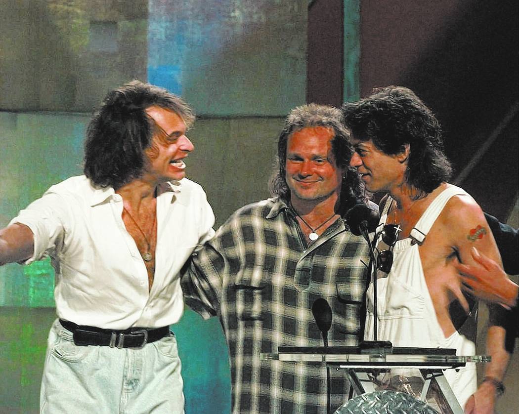 David Lee Roth, left, reunites with former bandmates Michael Anthony, center, and Eddie Van Halen at the MTV Video Music Awards in New York Wednesday, Sept. 4, 1996. (AP Photo/Bebeto Matthews)