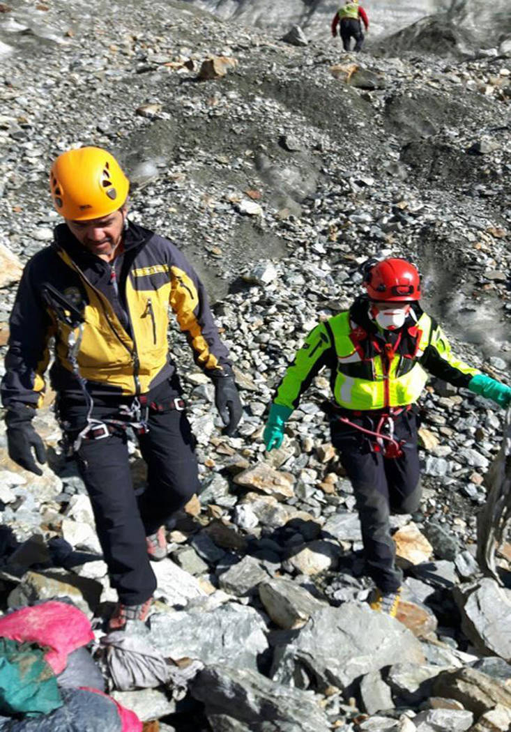 Italian Guardia di Finanza and Firefighters officers inspect the area where corpses were spotted on Mont Blanc's Southern face on Aug. 24.  (Italian Firefighters/ANSA via AP)