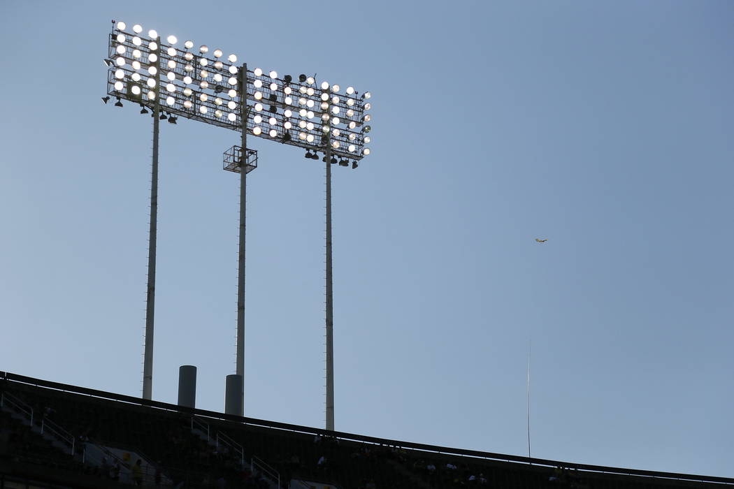 A vinyl kite, at right, used to ward off seagulls, flies over the top deck of the Oakland Coliseum in Oakland, Calif., on Aug. 1. (AP Photo/Eric Risberg)
