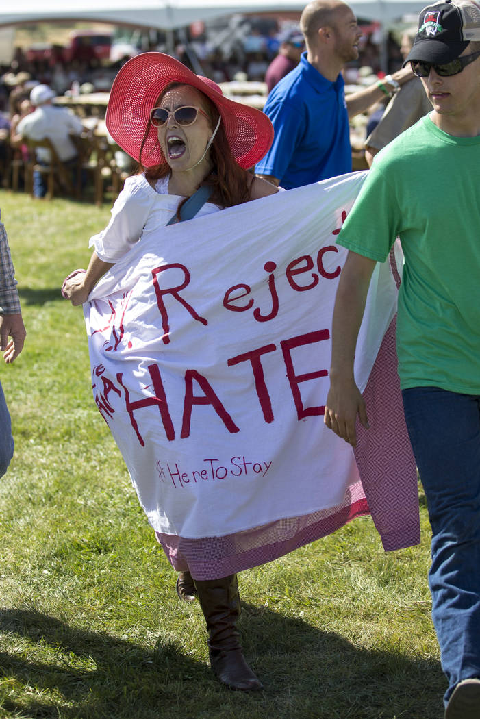 Protestor Autumn Zemke, with Northern Nevada Working Families, is escorted out after interrupting Nevada Attorney General Adam Laxalt during the 3rd annual Basque Fry held at Corley Ranch in Gardn ...