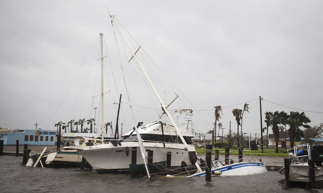 A boat sits capsized in the Rockport marina after Hurricane Harvey ripped through Rockport, Texas, on Saturday, Aug. 26, 2017.  The fiercest hurricane to hit the U.S. in more than a decade spun ac ...