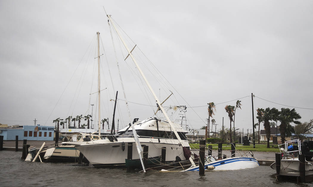 A boat sits capsized in the Rockport marina after Hurricane Harvey ripped through Rockport, Texas, on Saturday, Aug. 26, 2017. The fiercest hurricane to hit the U.S. in more than a decade spun ac ...