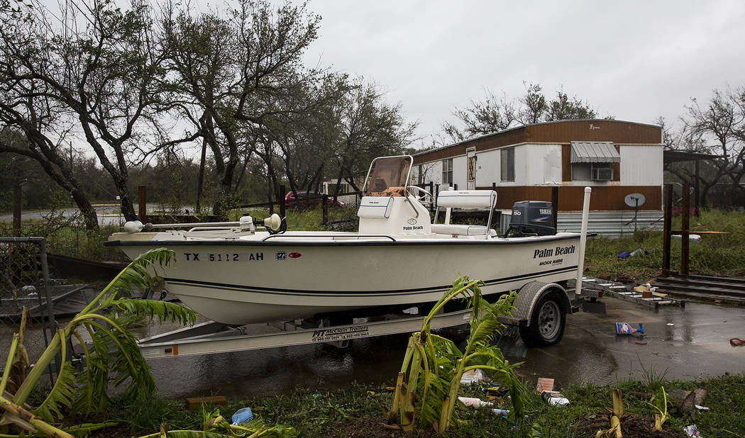 A boat sits in a driveway with debris strewn around it after Hurricane Harvey ripped through Rockport, Texas, on Saturday, Aug. 26, 2017.  The fiercest hurricane to hit the U.S. in more than a dec ...
