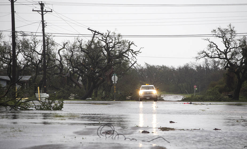 A vehicle drives through flooded roads after Hurricane Harvey ripped through Rockport, Texas, on Saturday, Aug. 26, 2017. The fiercest hurricane to hit the U.S. in more than a decade spun across ...