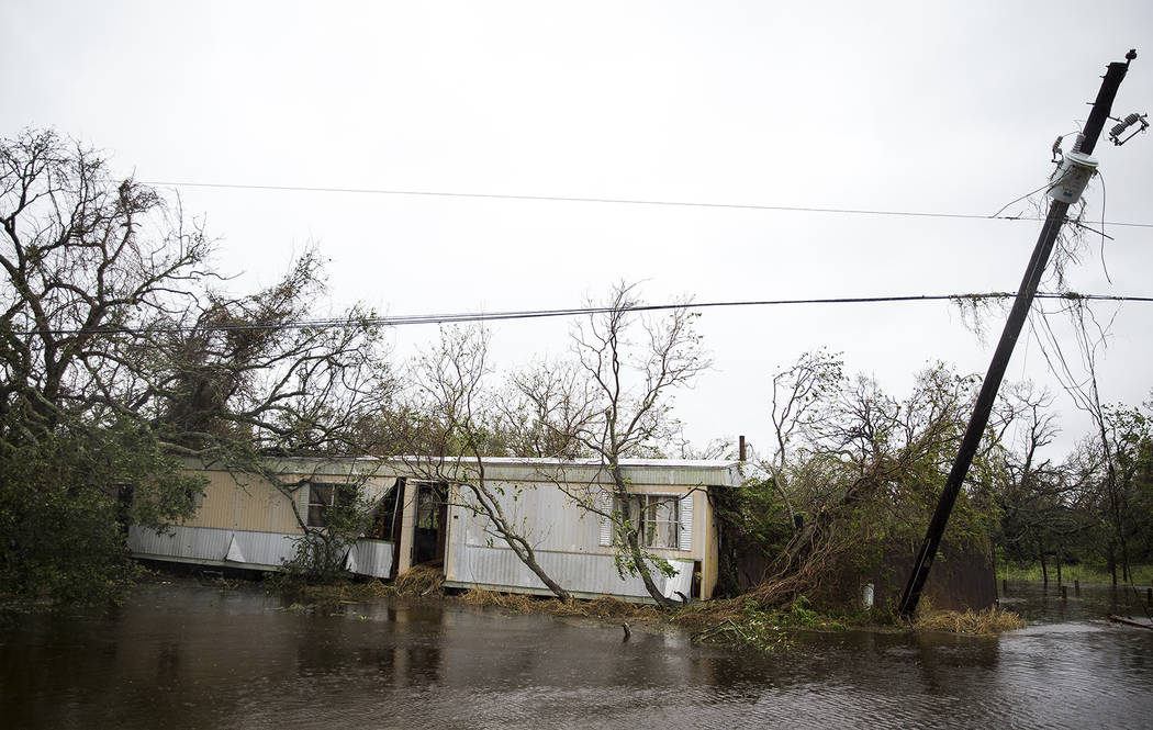 A trailer home sits lodged in trees after Hurricane Harvey ripped through Rockport, Texas, on Saturday, Aug. 26, 2017. The fiercest hurricane to hit the U.S. in more than a decade spun across hun ...