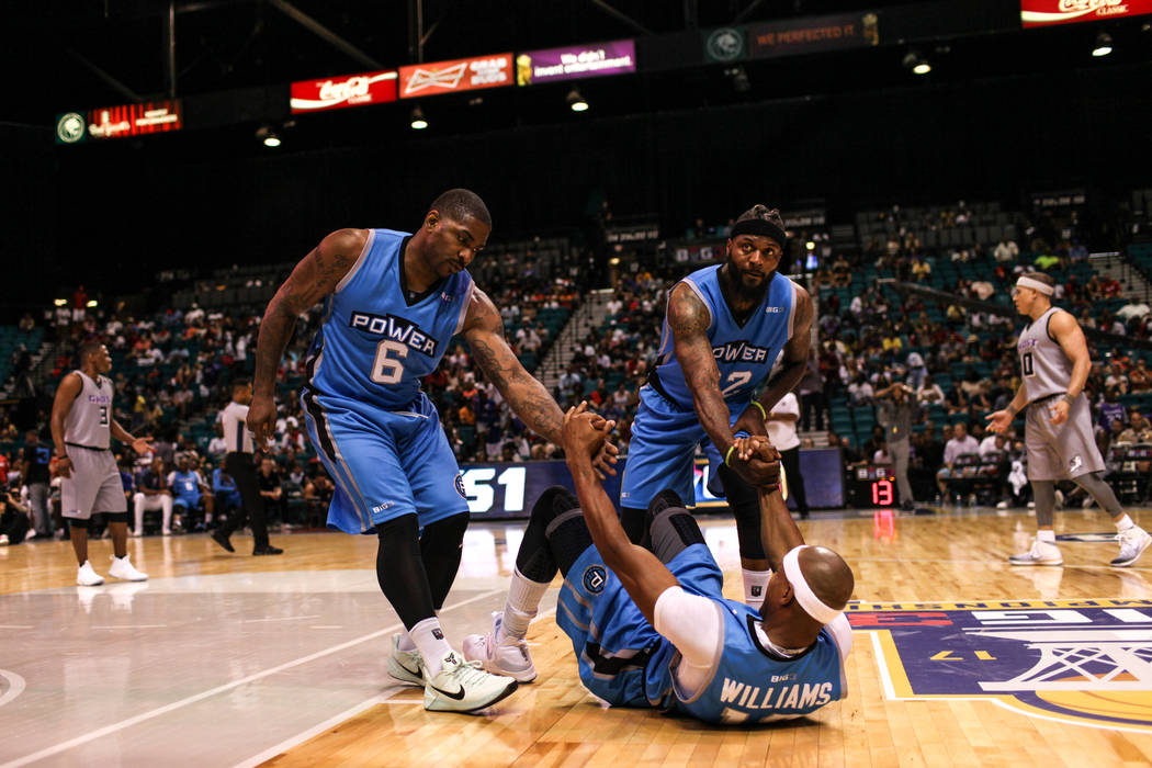 Power's Jerome Williams (13) is helped up by teammates Paul McPherson (6) and DeShawn Stevenson (92) during the second half of the runner-up game of the Big 3 Championship at the MGM Grand Garden  ...