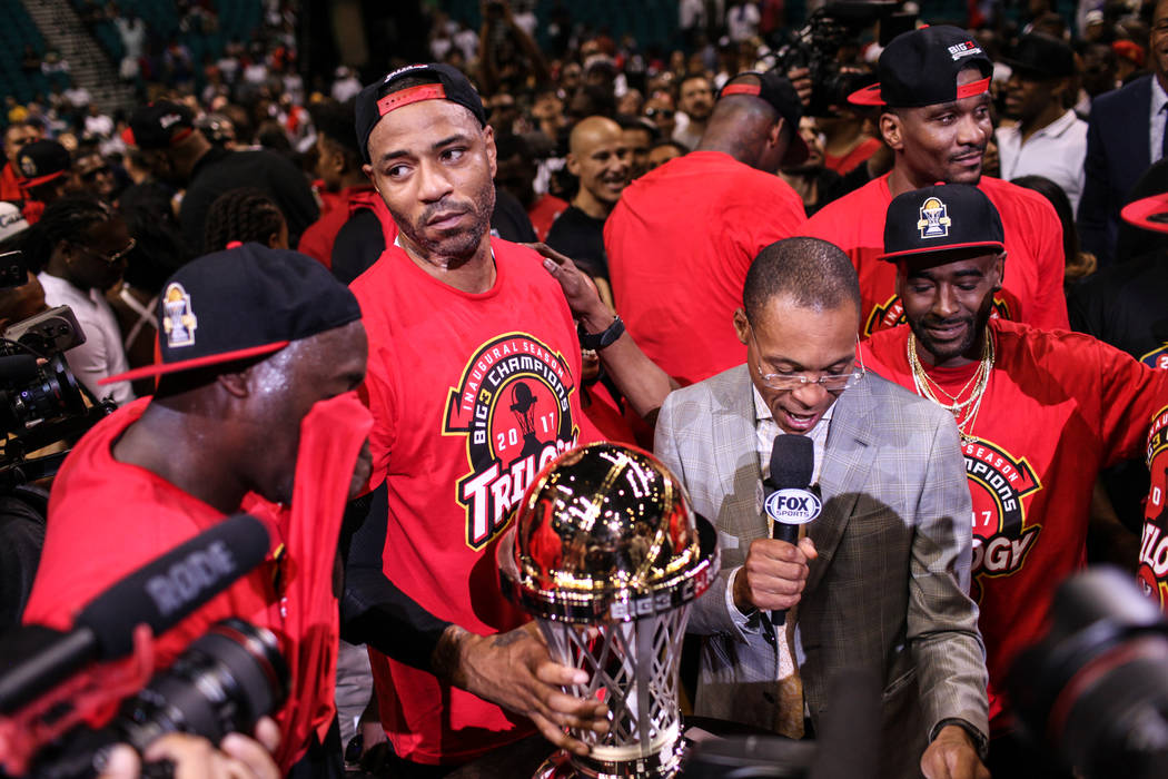 Trilogy's James White (8) gathers with his team as he holds the winning trophy after defeating the 3 Headed Monsters in the Big 3 Championship match at the MGM Grand Garden Arena in Las Vegas on A ...