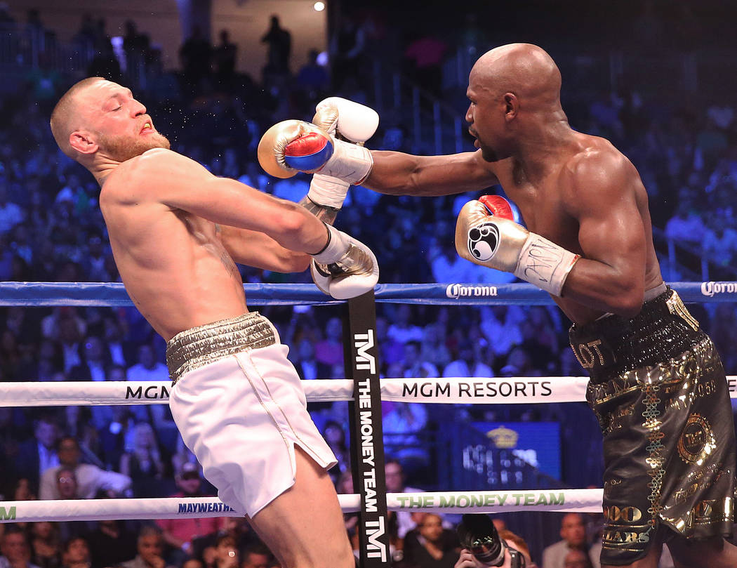 Floyd Mayweather, right, lands a punch against Conor McGregor in the blank round on Saturday, Aug 26, 2017, at T-Mobile Arena, in Las Vegas. Benjamin Hager Las Vegas Review-Journal @benjaminhphoto
