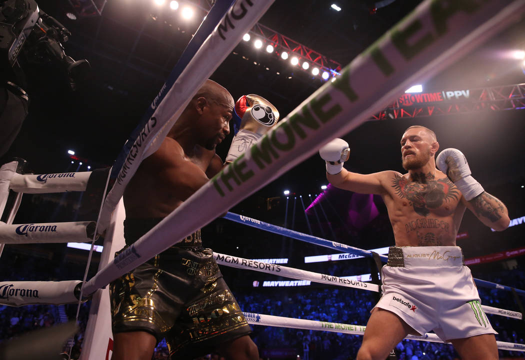 Floyd Mayweather Jr. blocks a punch from Conor McGregor during the first round of their fight at T-Mobile Arena, Saturday, Aug. 26, 2017, in Las Vegas. Benjamin Hager Las Vegas Review-Journal
