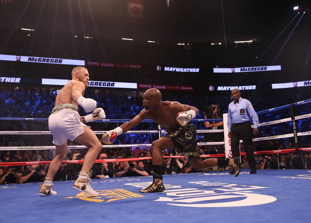 Conor McGregor, left, and Floyd Mayweather Jr. during the first round of their fight at T-Mobile Arena, Saturday, Aug. 26, 2017, in Las Vegas. Benjamin Hager Las Vegas Review-Journal