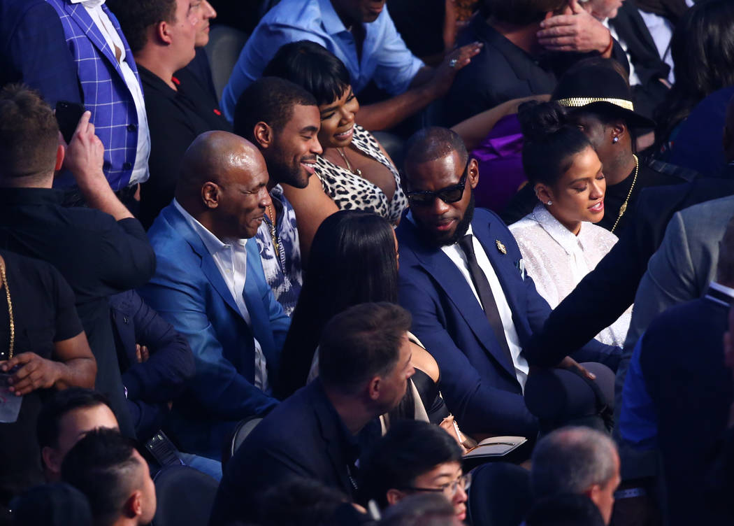 Former boxer Mike Tyson, left, and NBA superstar Lebron James seated before the Floyd Mayweather Jr. and Conor McGregor fight at T-Mobile Arena, Saturday, Aug. 26, 2017, in Las Vegas. Chase Steven ...